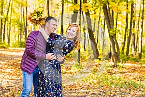 Love, relationship, family and people concept - couple in autumn park