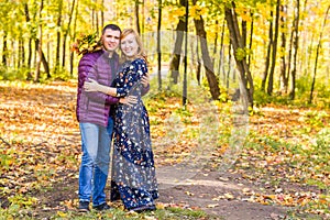 Love, relationship, family and people concept - couple in autumn park