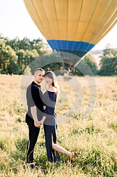 Love, relationships, engagement, happy anniversary concept. Smiling young couple man and woman in black fashionable