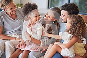 Love, relax and happy family introduction on sofa, laughing and playing in a living room together. Parents, kids and