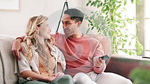 Love, remote or watching tv with interracial couple on sofa in home living room together for subscription entertainment