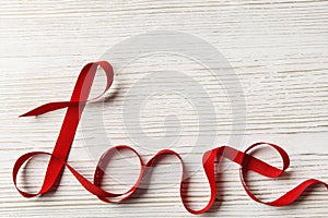 Love Ribbon Twisted Word, Wooden Background. Valentine Day Concept