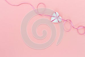 Love romance holiday concept for wedding or Valentines Day. Lovely heart with pink tape ribbon