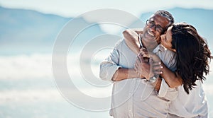 Love, romance and mature couple on beach, embrace and kiss with happy relationship and mockup. Romantic retirement