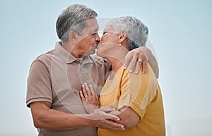 Love, romance and old couple kiss on marriage anniversary holiday vacation in retirement outdoors. Elderly, trust and