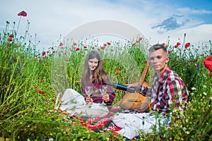 love and romance. opium. spring countryside. lovers with guitar in flower field. music.