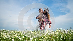 love and romance. spring countryside. lovers in daisy flower field. couple in love.
