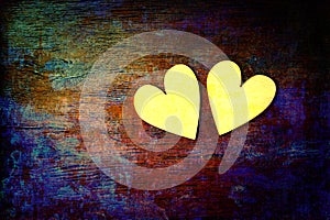 Love and romance. Two hearts on abstract multicolored background with wooden texture