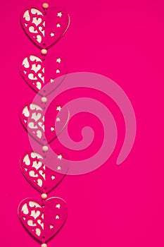 Love, romance, Valentines Day concept, toned felt fabric hearts design on contrasting hot pink background, ample copy space