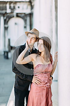Love - romantic couple in Venice on Piazza San Marco. Young couple on travel vacation holidays hugging and embracing having fun on
