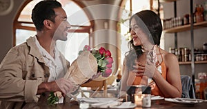 Love, roses and couple on date in restaurant for valentines day, anniversary or romantic celebration. Happy