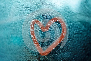 Love, Sadness, Loneliness and Unhappy in Relationship Concept. Red Heart Shape on Glass Window