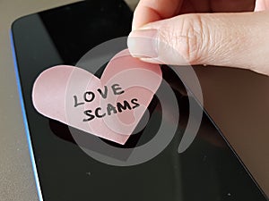 Love Scam awareness concept. A person tricked by online romance scam photo