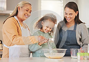 Love is always the secret ingredient. a little girl baking with her mother and grandmother at home.