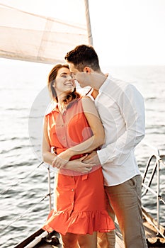 Love on the ship, couple in love hug on a yacht at sea