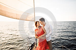 Love on the ship, couple in love hug on a yacht at sea