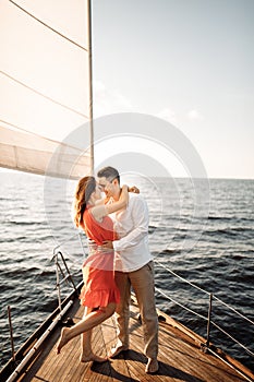 Love on the ship, couple in love hug on a yacht at sea