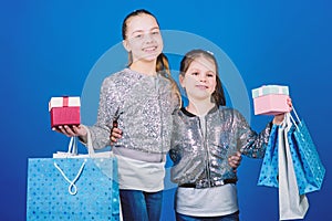 We love shopping. Small girls with shopping bags. Sisterhood. Holiday purchases. Kid fashion. shop assistant with