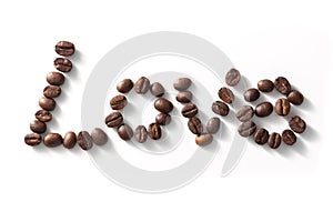 Love sign with coffee beans arranged over white background