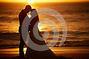 Love, silhouette and couple with beach sunset bond, relax and enjoy quality time, peace and freedom of the ocean sea