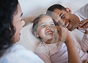 Love, smile and happy family in a bed laughing, bonding and playing in their home together. Face, playful and girl child