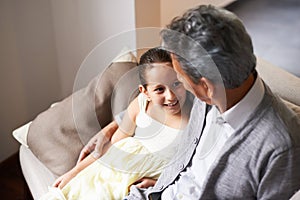 Love, smile or happy grandfather with a girl hugging with care in family home on holiday break together. Elderly