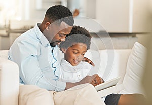 Love, sofa and father reading with his child while relaxing together in the living room of their home. Happy, bonding