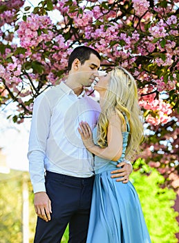 Love story. Loving people hug. Passion concept. Man and woman in blooming garden. Couple spend time in spring tree