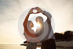 Love Story. Romantic Mature Couple Making Heart Shape With Hands On Sunset