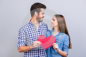 Love story. Trust and feelings, emotions and joy. Happy young lovely couple in love is posing, wearing casual shirts, holding big