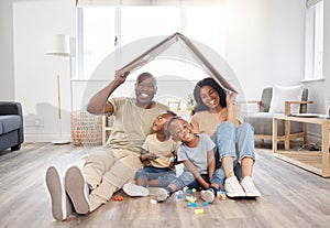 Love is the strongest foundation on which to build a family home. a happy young family making a gesture above themselves