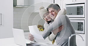Love and support couple with man on laptop with paperwork, bills and mortgage in kitchen. Happy marriage and woman