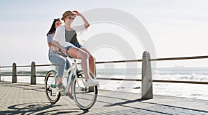 Love is supposed to be filled with fun and happiness. Full length shot of a happy young couple riding a bicycle together