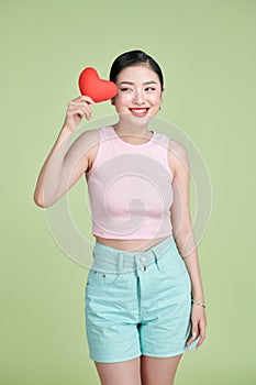 Love symbol. Asian woman with red heart on white background