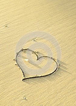 Love symbol etched on the sand.