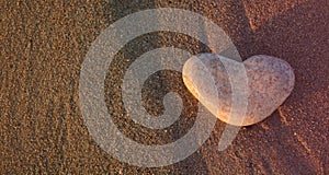 Love symbol. Heart of stone on the pebble beach. Valentine background