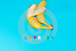 Love is a text of colored letters. Two bananas together, the concept of love and family relationships of opposite-sex marriages photo