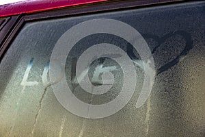 Love text and heart symbols. Love expression. Inscription on sweaty auto car window.