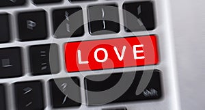 LOVE text on red button of computer keyboard