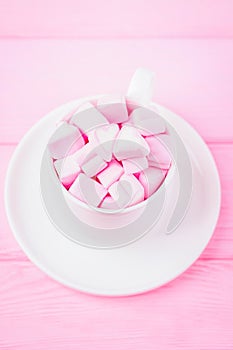 Pink marshmallow hearts in a cup. Valentine`s day background. Copy space