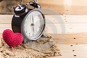 Love time, retro clock with love heart on wood background