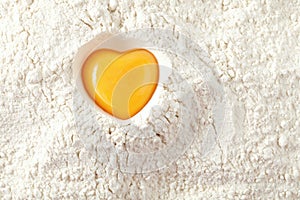 Love to bake it! egg yolk on flour photo