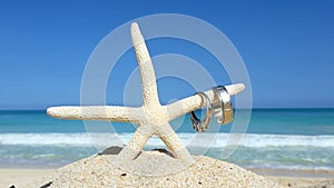 Love travel concept Wedding rings and starfish on tropical beach Oahu Hawaii