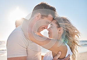 Love, travel and couple hugging at the beach while on a seaside date or honeymoon vacation. Affection, romance and young