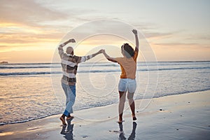 Love, travel and happy couple at beach enjoying summer vacation or fun honeymoon at sunset while holding hands and being