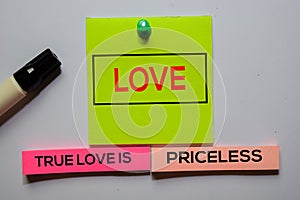 Love. True Love Is Priceless text on sticky notes isolated on office desk