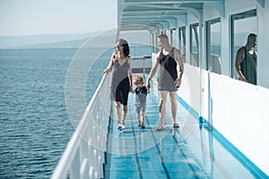 Love and trust as family values. Child with father and mother. Mother and father with son in sea trip. Family ship
