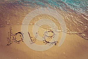 Love and Valentine concept. Love words written into the sand on the beach at Rayong, Thailand