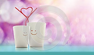 Love and Valentines Day Concept. Happy Lover Coffee Cup with smiley face and Straw in Heart Shape, Happiness and Romantic