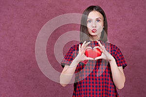 Love and valentines day woman holding heart smiling cute and adorable on pink background